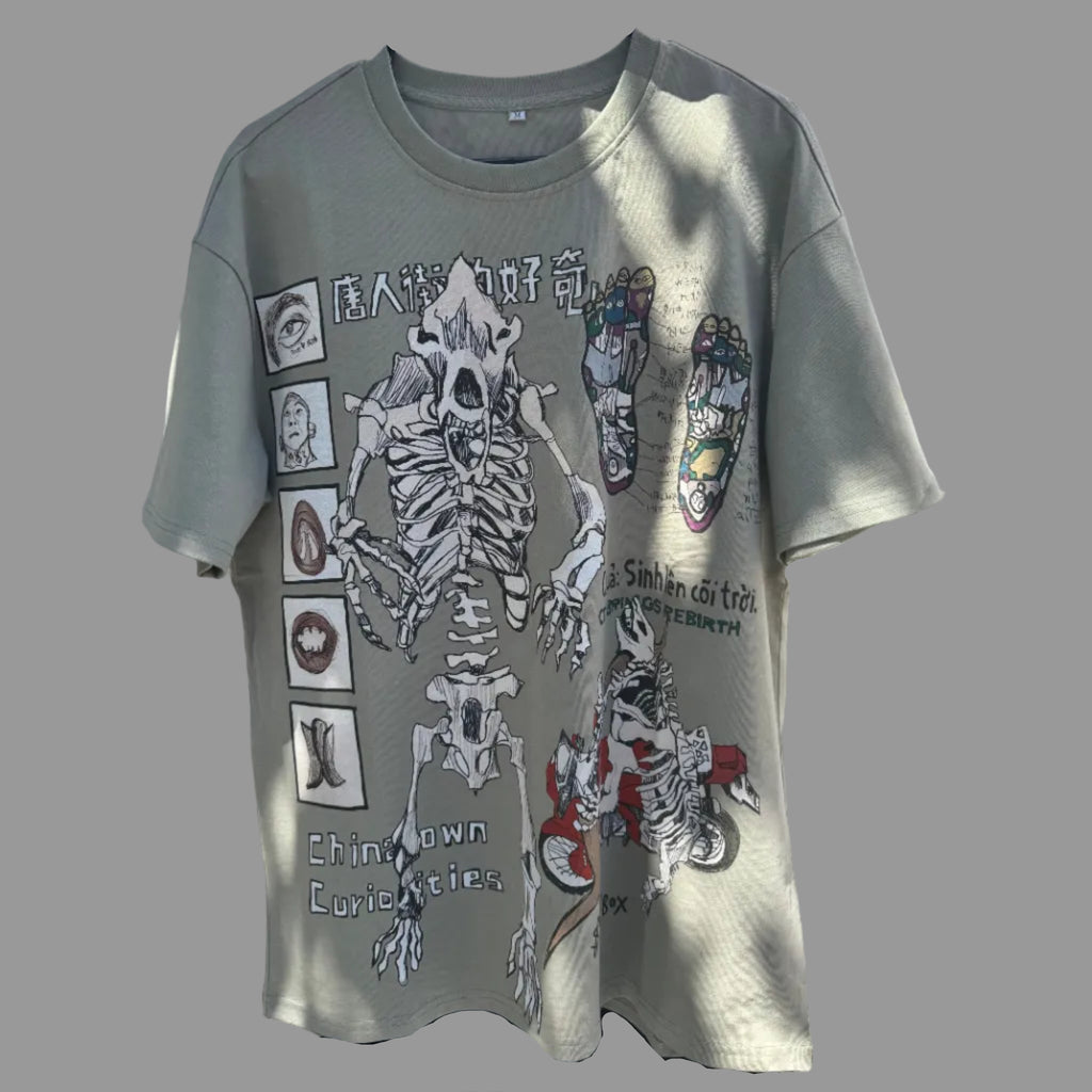 Gray t-shirt with skeleton design hanging under a white tent